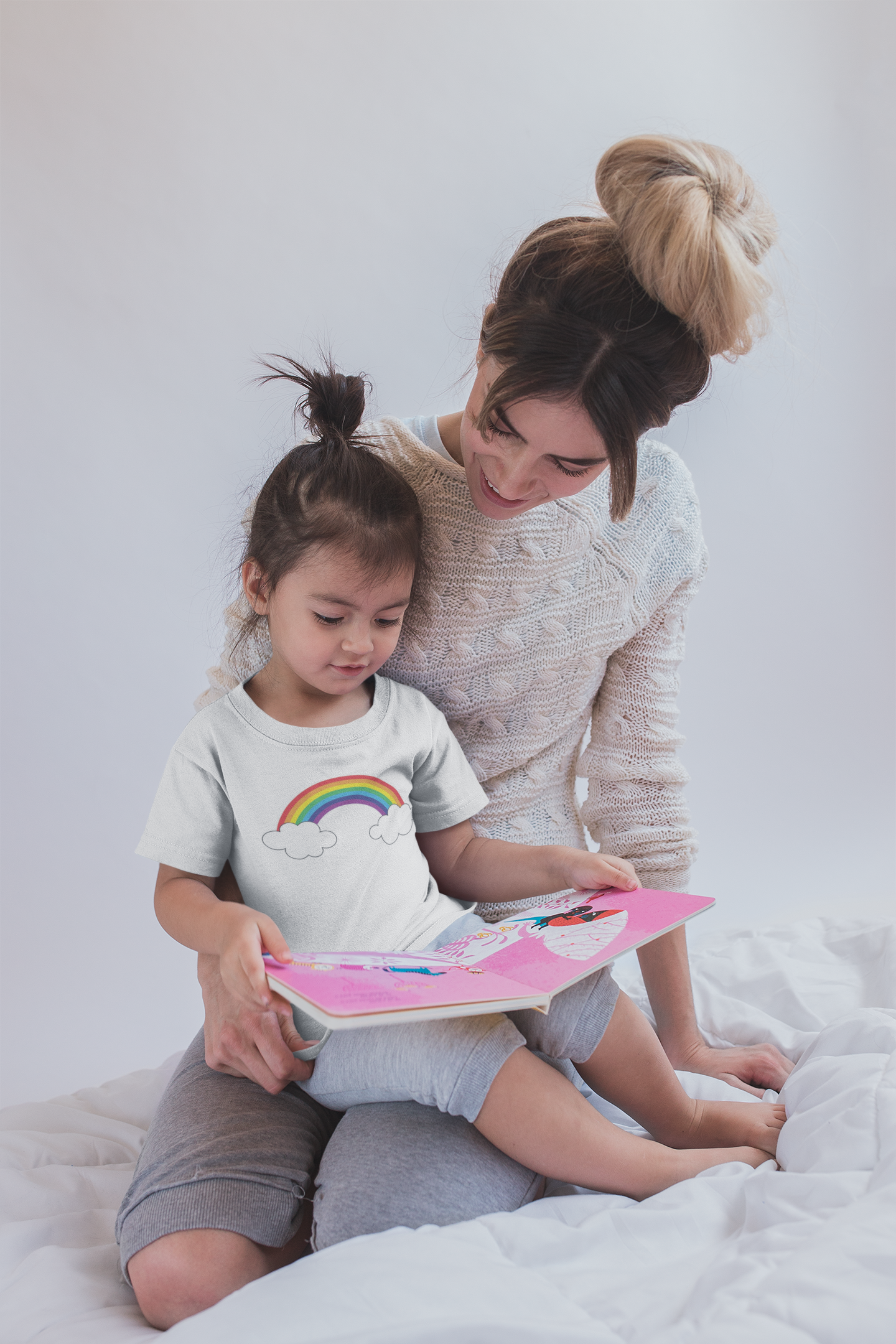 girl-reading-a-book-wearing-a-t-shirt-mockup-with-her-mom-sitting-on-bed-a20285